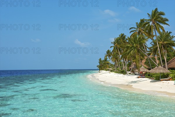 View of beach with turquoise blue water in shallow lagoon of Maldives island Filaidhoo in Indian