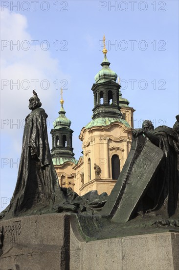 Jan Hus Monument on the Old Town Square and the towers of St Nicholas Church, Prague, Czech