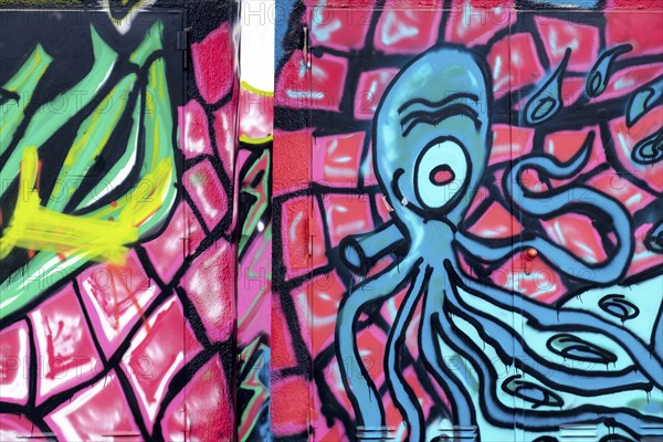 Graffiti of a blue octopus on a pink and green background, Landau, Rhineland-Palatinate, Germany,