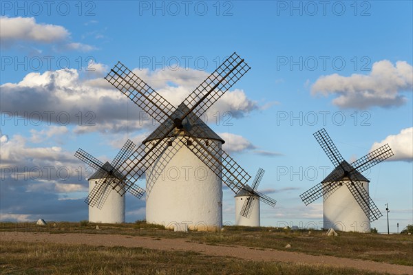 Windmills in a vast and idyllic landscape under a blue sky with clouds, Windmills, Campo de
