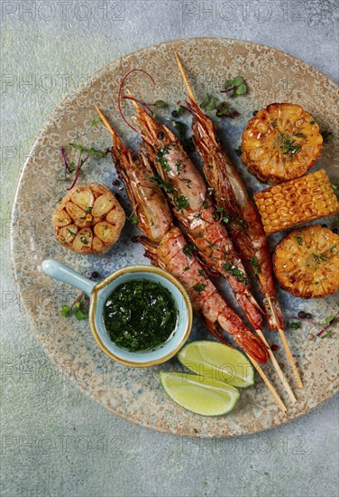 Langoustines on skewers, shrimp kebab, with fried corn, spices and herbs, homemade, no people