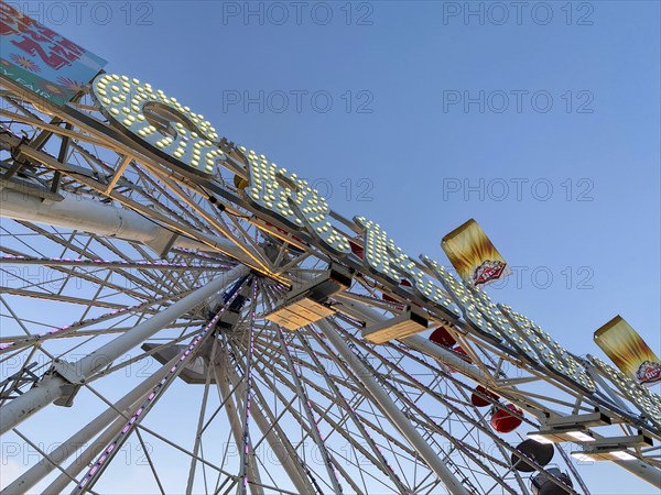 Ferris wheel, bottom view of a ferris wheel against the blue sky. San Diego County Fair,
