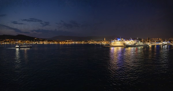 Harbour at night, illuminated ships with their light reflections in the water, Split, Dalmatia,