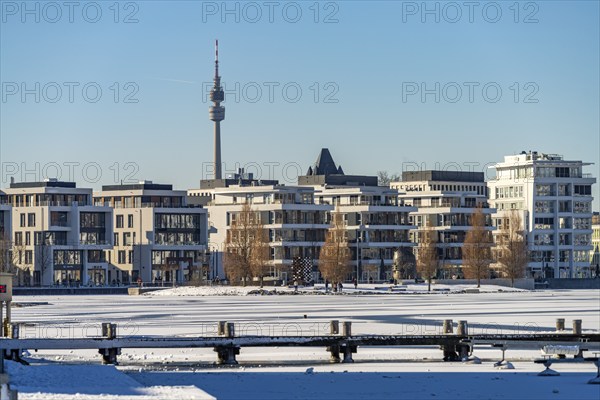 View of the snow-covered and frozen Phoenix Lake and the Florian television tower in Dortmund,