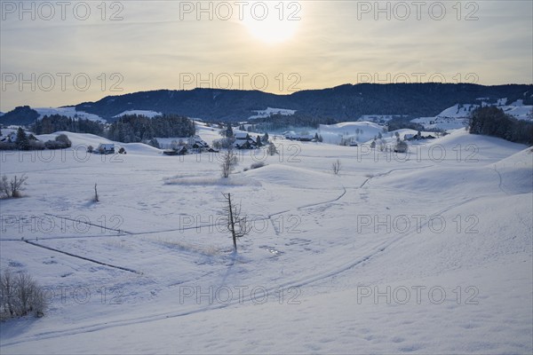 Snowy landscape with farms, rolling hills and mountains in the sunlight, Menzingen, Zug, Canton