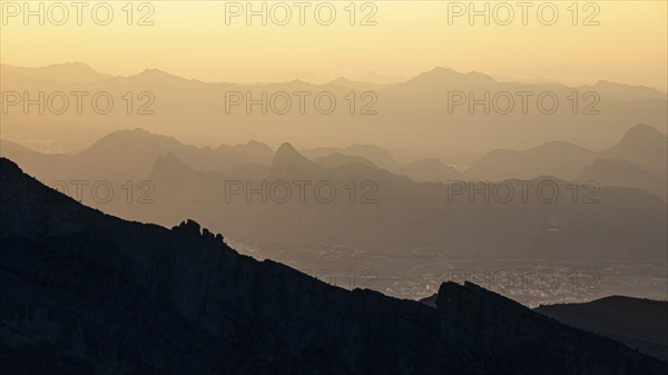 View from the mountain plateau Al Hayl into the valley, below the village of Ghul, behind in the
