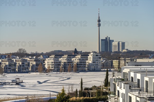 View of the snow-covered and frozen Phoenix Lake and the Florian television tower in Dortmund,