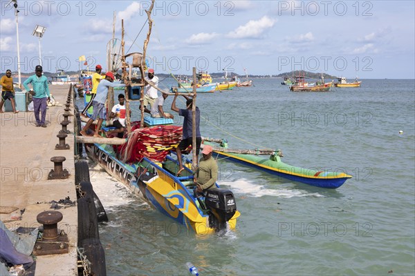 Sri Lankan fishermen on colourful outrigger boat on the Indian Ocean, Kapparatota, Matara, Southern