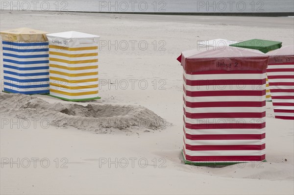 Striped beach chairs in various colours on the sandy beach, Borkum, l North Sea, GERMANY