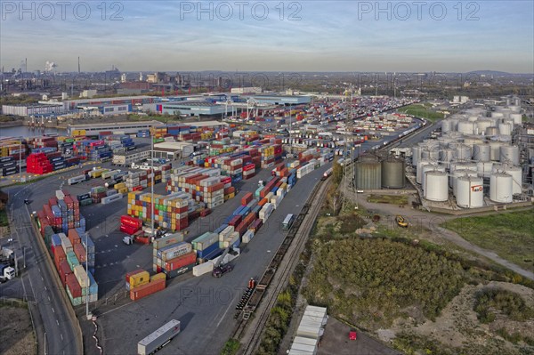 Commercial port with container terminal and oil tanks at the Rhine river in North Rhine-Westphalia,