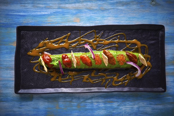 Modern guacamole avocado sauce with fresh coriander