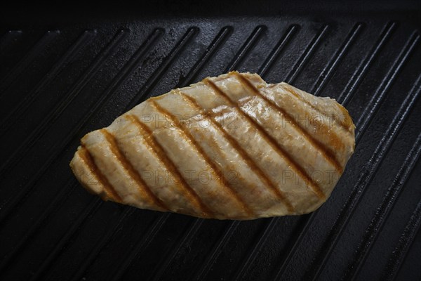 Grilled chicken breast on grill pan background