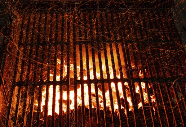Bar-b-cue grill barbecue with red ashes and sparkles in fire