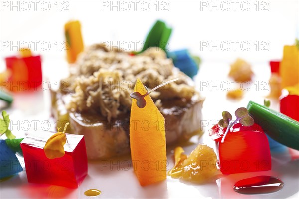 Foie slice with grated white truffle and colorful jelly decoration