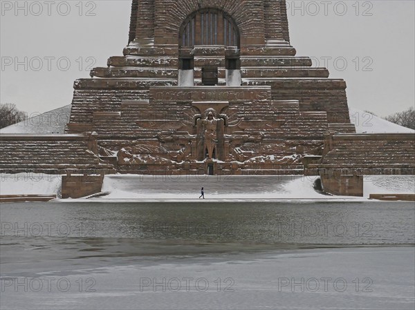 Lonely hiker at the wintry Völkerschlachtdenkmal. Leipzig, Saxony, Germany, Europe