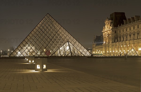 Paris, France, March 15, 2011: Glass pyramids in the Louvre late in the evening, Europe