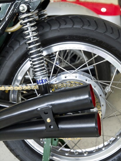 Detail of a motorbike with swing arm suspension and classic twin exhausts, doesburg, Netherlands