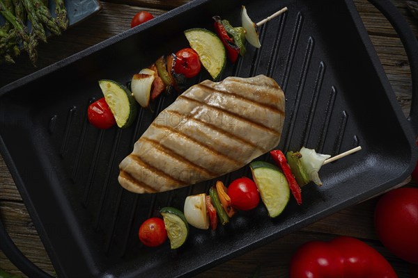 Grilled chicken breast with brochette vegetable on grill pan