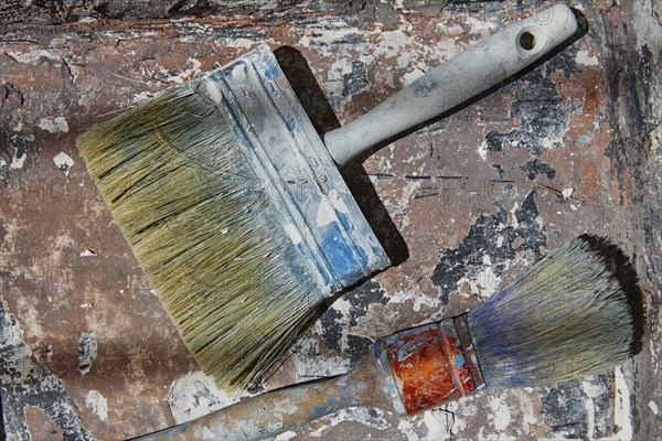 Paint brushes used on grunge bucket in improvement background