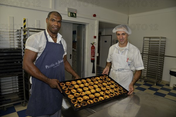 Two employees of the Confeitaria dos Pastéis de Belém pastry shop with the famous pastéis cream