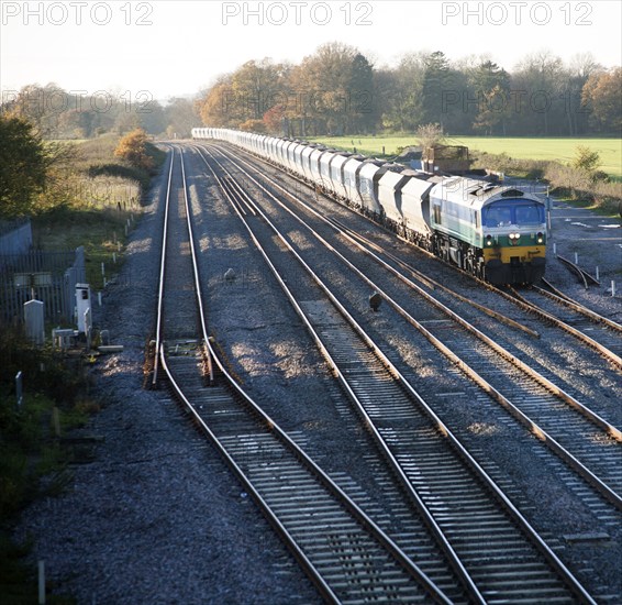 Diesel locomotive freight train on the West Coast mainline at Woodborough, Wiltshire, England, UK
