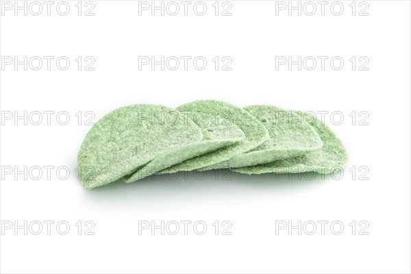 Green potato chips isolated on white background. Side view, close up