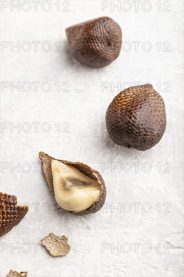 Salak or snake fruit on gray concrete background. Side view, close up. Tropical, healthy food,