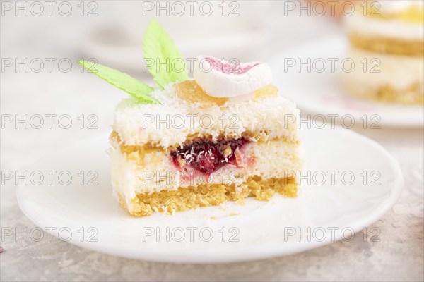 Decorated cake with milk and coconut cream with cup of coffee on a gray concrete background and