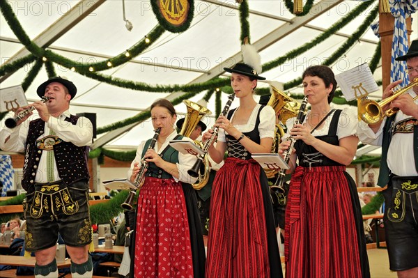 Musicians of a Bavarian brass band in traditional traditional costume playing the clarinet, old