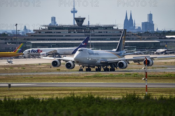 Cologne-Bonn Airport, CGN, UPS cargo aircraft, Boeing 747 jumbo jet, on landing, tower at the