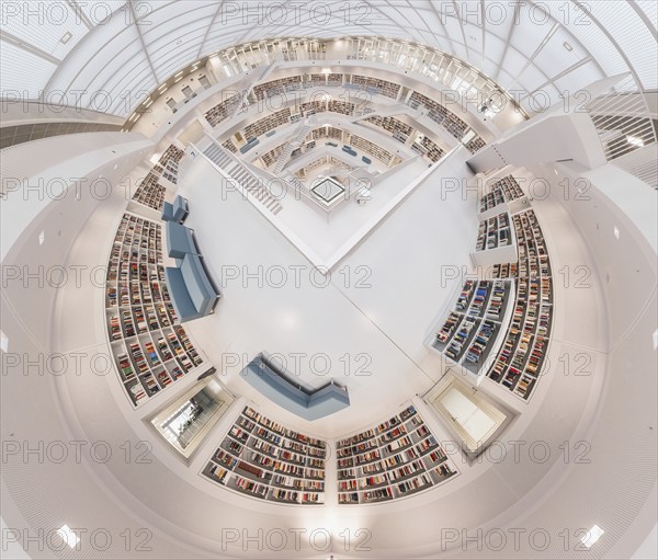 Modern library with symmetrical design and numerous bookshelves in a futuristic white interior,