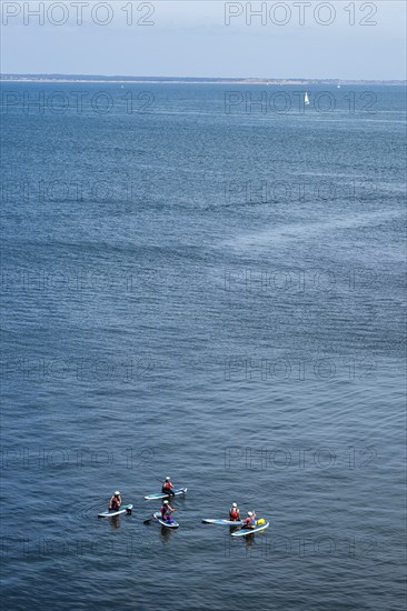 People on paddleboards, White Cliffs. Old Harry Rocks Jurassic Coast, Dorset Coast, Poole, England,