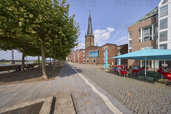 St. Lambert's Basilica with restaurants and riverside promenade with Platanus × acerifolia trees