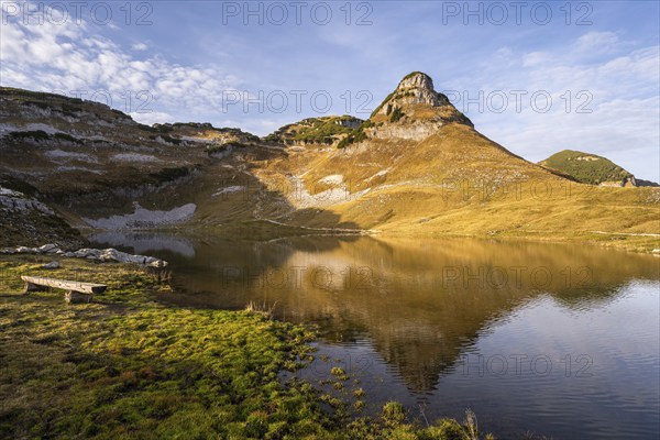 Lake Augstsee and the Atterkogel mountain on the Loser. A bench on the left. Autumn, good weather,