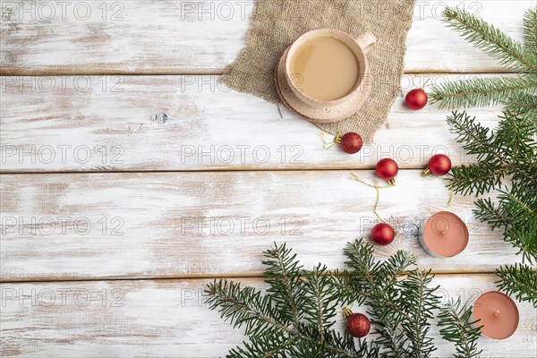 Christmas or New Year composition. Decorations, red balls, fir and spruce branches, cup of coffee,