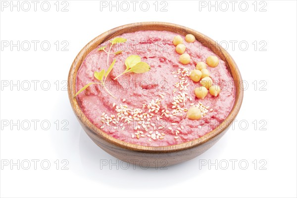Hummus with beet in wooden bowl isolated on white background. Side view, close up