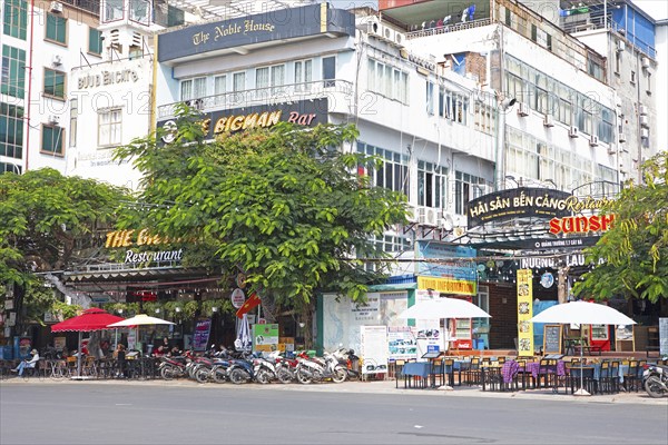 Mopeds and restaurants on the harbour promenade of Cat Ba Town, Cat Ba Island, Halong Bay, Vietnam,