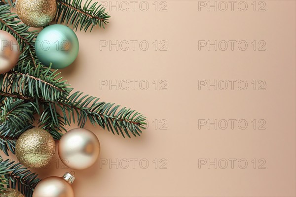 Christmas flatlay with blue and cream colored tree baubles and fir branches on beige background