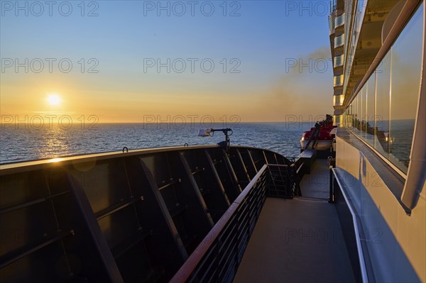 Deck of a ship at sunrise with clear sky and blue railing, Mein Schiff 6, North Sea, Denmark,