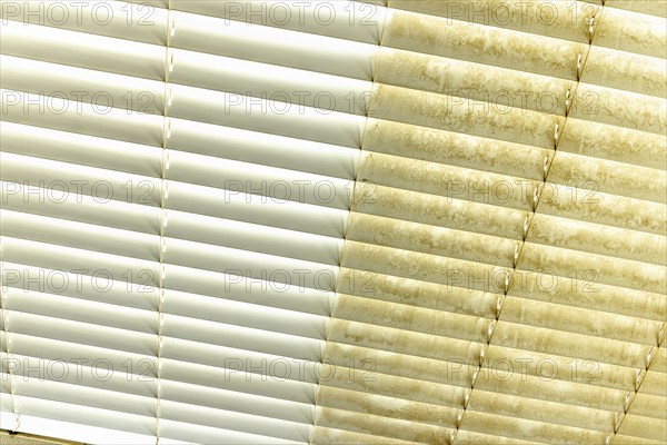 Residential window shades showing the before and after of a good cleaning, one side clean and one