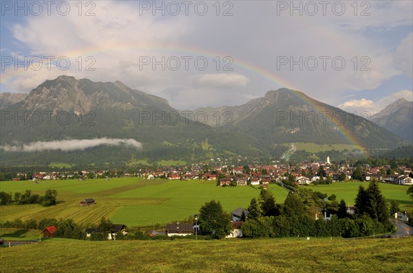 View over Oberstdorf with rainbow on Rubihorn and Geißalphorn, Schattenberg on the right,
