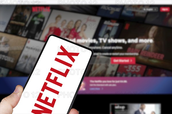 Netflix logo online video streaming platform on a mobile phone and computer in Stuttgart, Germany,