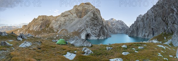 Wild camping, camping in the wilderness with a tent in front of mountain lake Kol Suu, Sary Beles