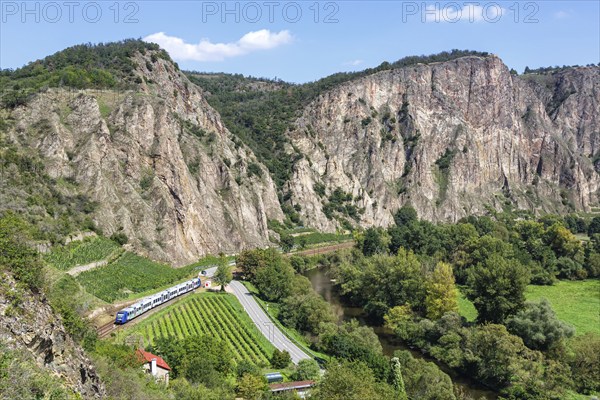 The Rotenfels with an Alstom Coradia LINT regional train operated by Vlexx in Traisen, Germany,