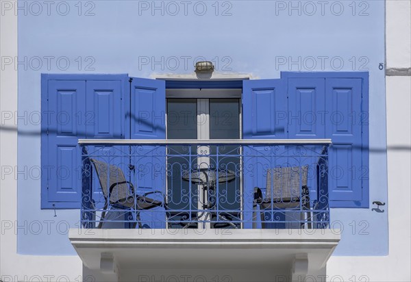 Balcony on a white house, blue door and window shutters, Symi Island, Dodecanese, Greek Islands,