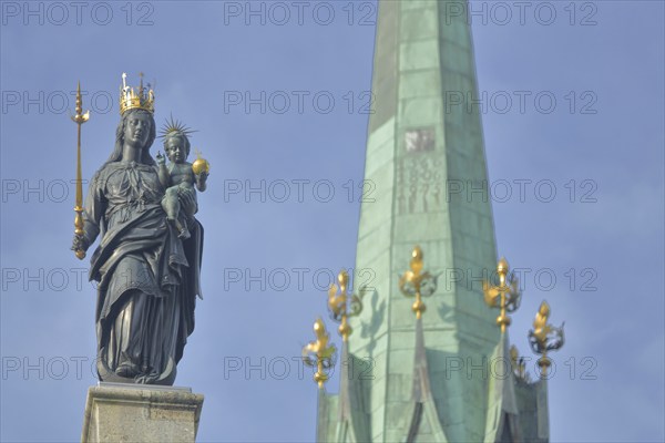 Madonna figure with golden crown and blurred spire of Our Lady, Minster, sceptre, baby Jesus, arm,