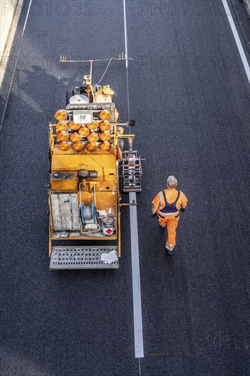 Marking work after the application of new whisper asphalt surface for the A40 motorway, in the