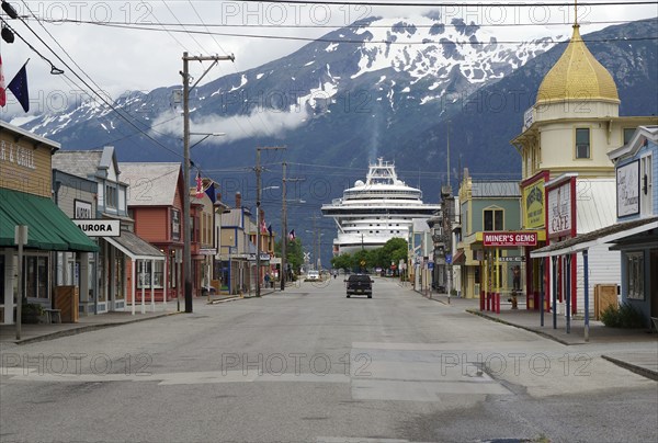 Historic wooden houses and a cruise ship, Skagway, Alaska, USA, North America