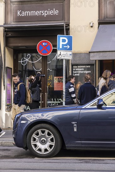Disabled parking space in front of a trendy bar on the fashionable shopping street Maximilianstraße