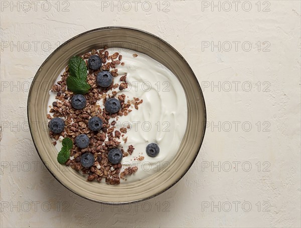 Yogurt with chocolate muesli, with berries, blueberries, breakfast, close-up, fork on top, no